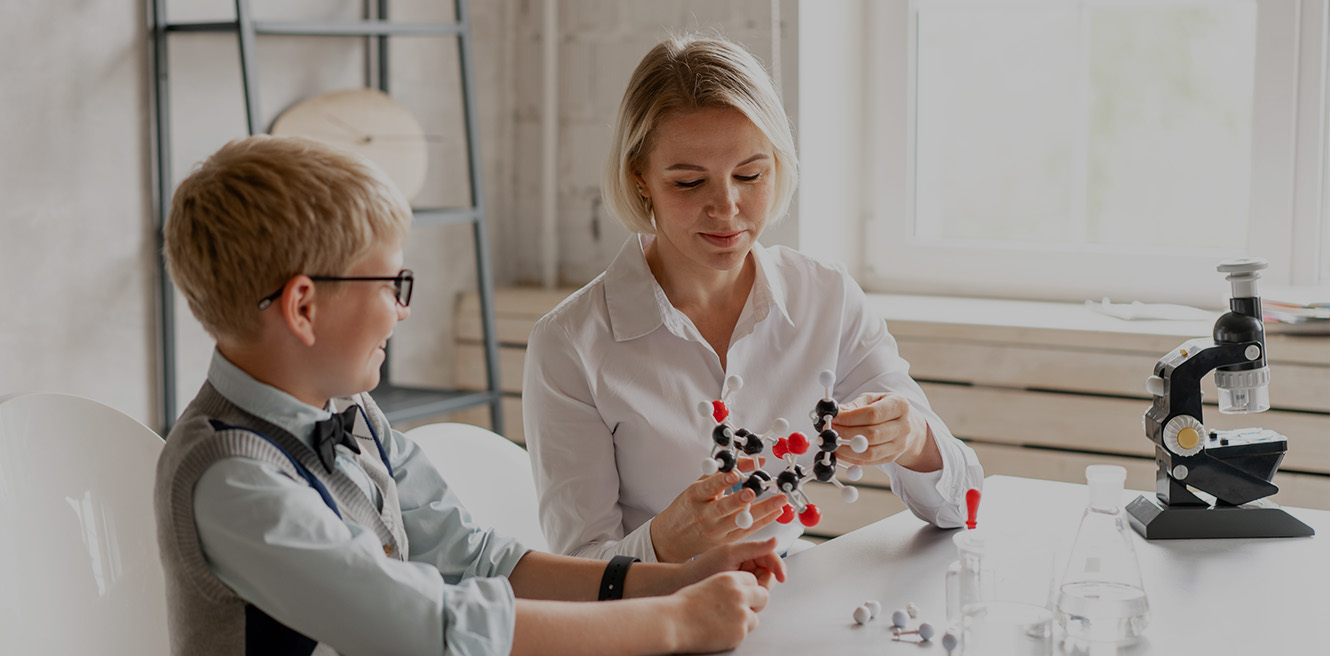 Female science tutor in Hillsboro studying chemistry with student